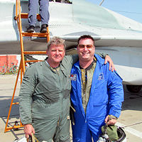 Blake wore a pressure suit under his custom flight suit for the climb to altitude. He is pictured here with Sokol Test Pilot Andrey Pechionkin.