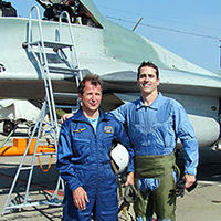 Jeff from Florida stops for a photo in front of the MiG-29 with Sokol Test Pilot Yuri Polyakov. Jeff completed an aerobatic mission in the MiG.
