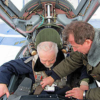 Sokol Test Pilot Yuri Polyakov checks to make sure Pat is tightly strapped into the MiG-29. All of the pilots at Sokol speak English.