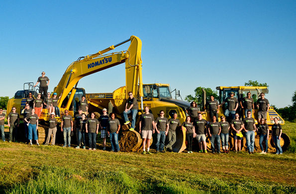 Large group driving heavy construction machinery at Hard Hat Adventures