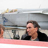Abe has a conversation with Sokol Test Pilot Yuri Polyakov before his flight. Behind him is a MiG-31.