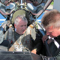 Ray's pilot for his flight to the edge of space was Sokol Test Pilot Andrey Pechionkin. MiG flyers are given final safety instructions by their pilot after being tightly strapped into the cockpit.