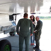 MiG flyers accompany their test pilot as he performs a final pre-flight check of the aircraft. All Sokol pilots speak some English, but Irina is always nearby to translate information as necessary.