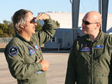 Customer Terry Witt talks with Starfighters Systems Engineer David "Picard" Gemas on the ramp at the Shuttle Landing Facility